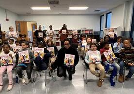 a photo of students holding Ruby Bridges' new book at a read-a-long